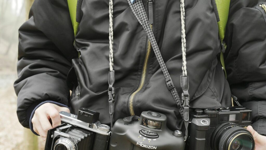 Professional Photographer with Vintage and Panoramic Cameras 4K Wallpaper