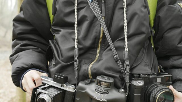 Professional Photographer with Vintage and Panoramic Cameras 4K Wallpaper