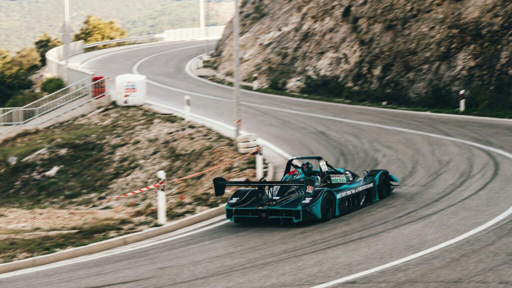 Cyan and Black Racing Car Drift Mountain Road 4K Wallpaper