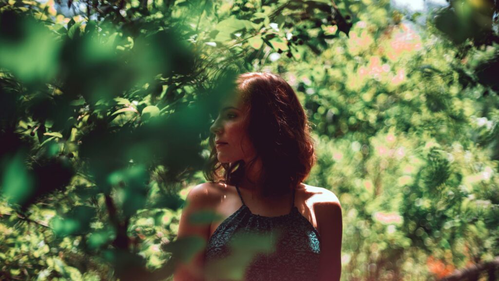 Dreamy Woman in Lush Green Garden Desktop Wallpaper