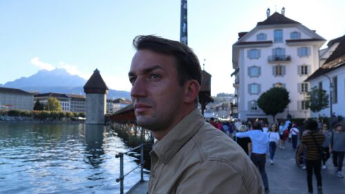 Man Posing Against Scenic Lucerne Cityscape 4K Desktop Wallpaper
