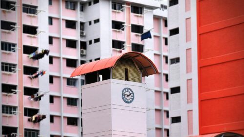 Minimalist Clock Tower Against Pink HDB Residential Building PC Wallpaper