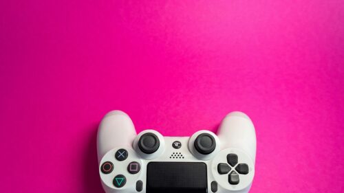 Minimalist White PS4 Controller on Vibrant Pink Background 4K Wallpaper