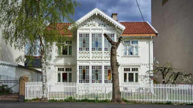 Charming Scandinavian Wooden House with Stained Glass Windows Desktop Wallpaper