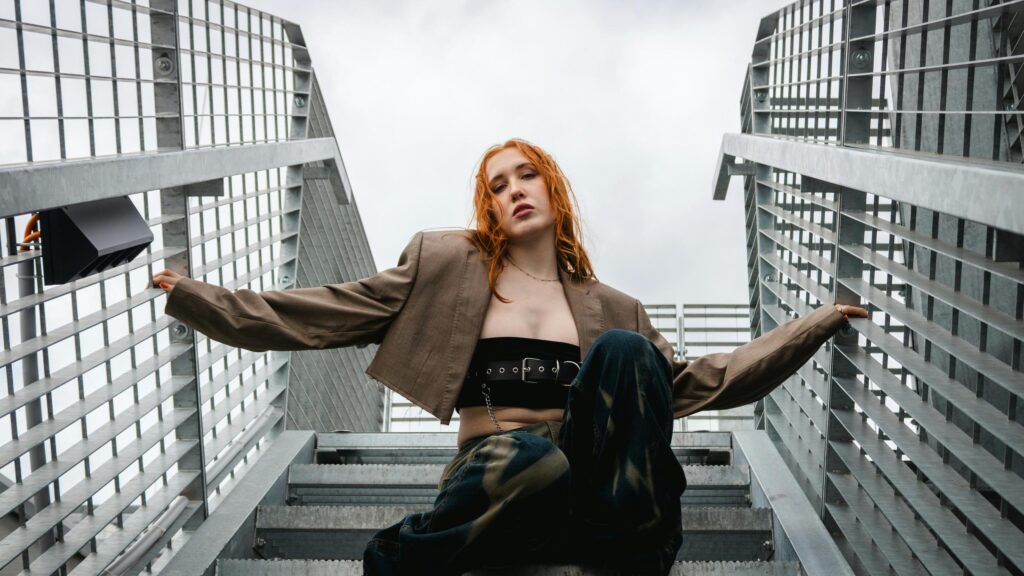 Edgy Fashion Portrait of Stylish Redhead Woman on Metal Stairs 4K Wallpaper