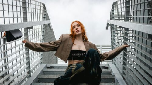 Edgy Fashion Portrait of Stylish Redhead Woman on Metal Stairs 4K Wallpaper