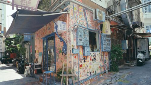 Vibrant Graffiti Art House Facade with Whimsical Drawings 4K Wallpaper