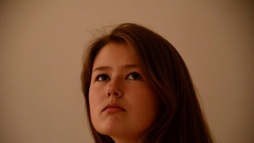 Thoughtful Young Woman Looking Up Portrait 4K Desktop Wallpaper