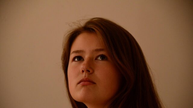Thoughtful Young Woman Looking Up Portrait 4K Desktop Wallpaper