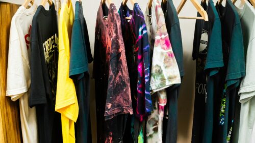 Colorful T-Shirt Collection Hanging on Rack 4K Desktop Wallpaper