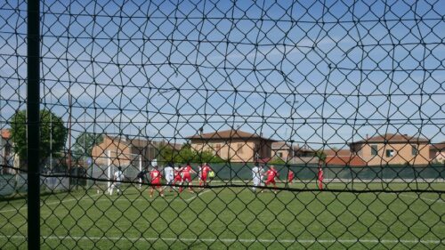 Amateur Football Match Field View Through Net 4K Desktop Wallpaper