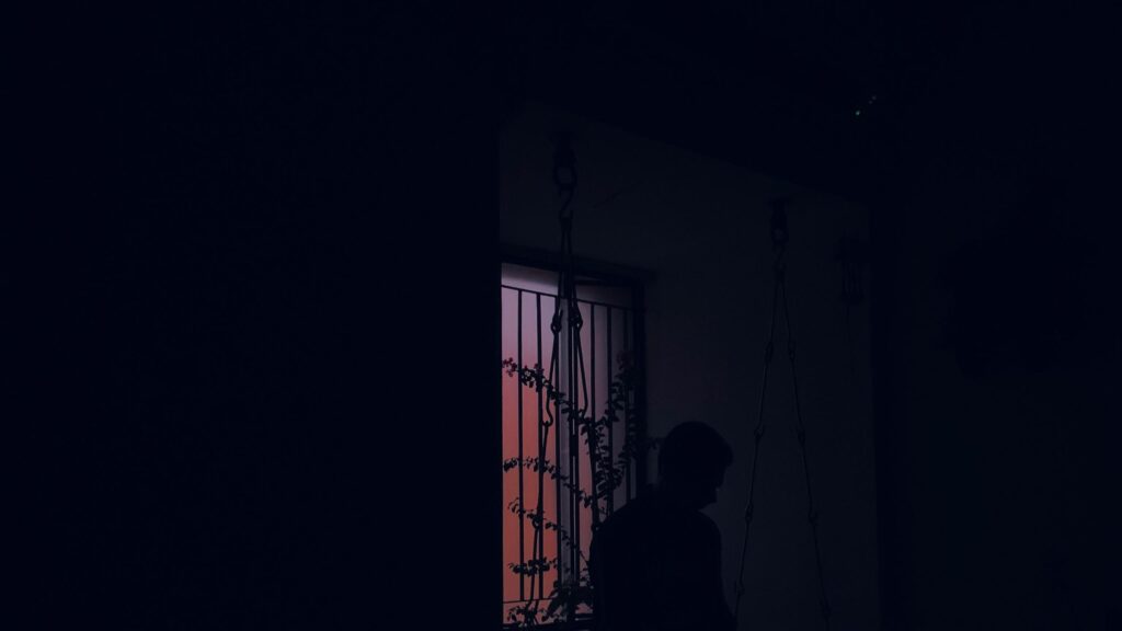 Silhouette of a Person Near a Window at Sunset Desktop Wallpaper