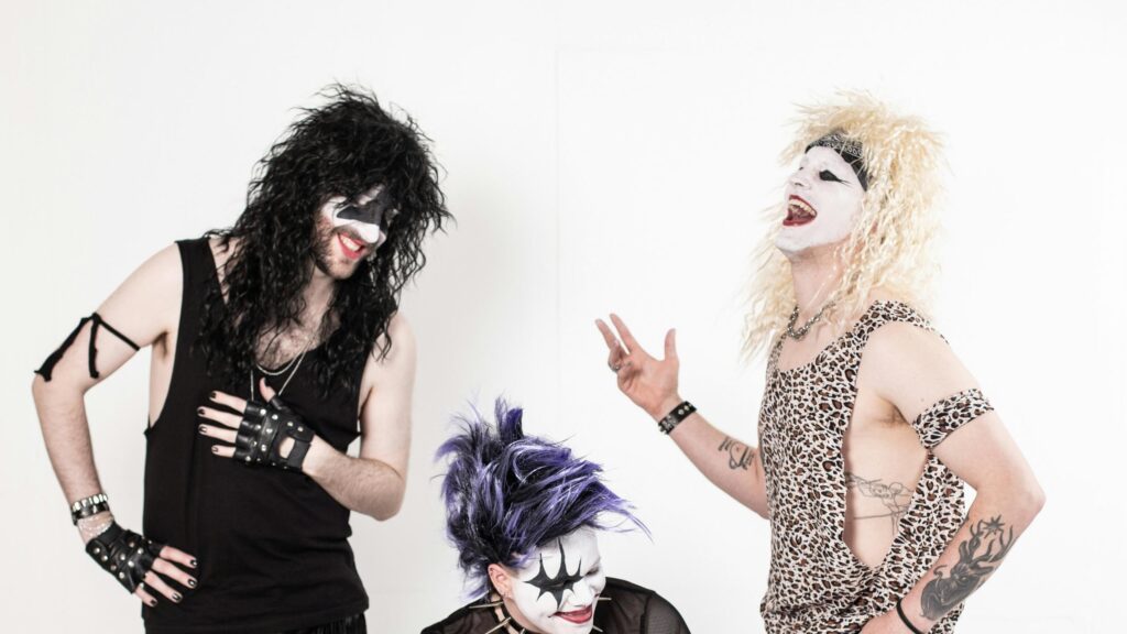 Glam Rock Band Members in Heavy Makeup Desktop Wallpaper