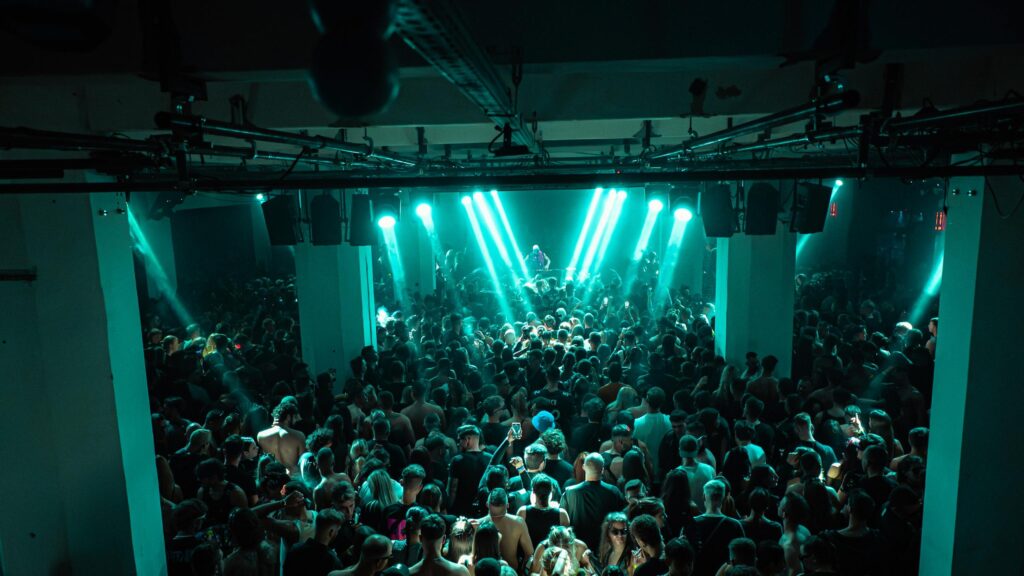 Immersive Club Night Party with Teal Stage Lights 4K Wallpaper