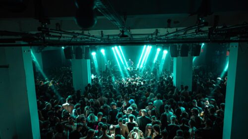 Immersive Club Night Party with Teal Stage Lights 4K Wallpaper