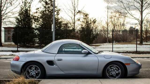 Silver Porsche Boxster Sports Car parked on a quiet street Desktop Wallpaper