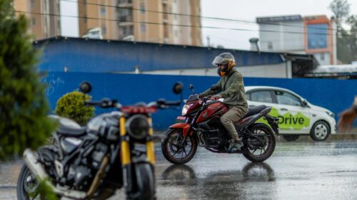 Motorcyclist Riding Through Rainy Streets Desktop Wallpaper