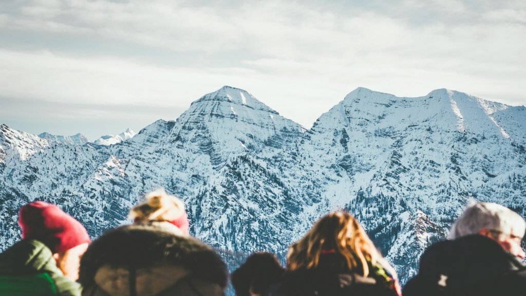Snowy Mountain Peaks With Hikers Viewing Landscape Desktop Wallpaper