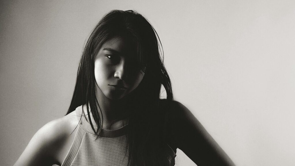 Dramatic Portrait of a Young Woman with Shadow Play 4K Wallpaper