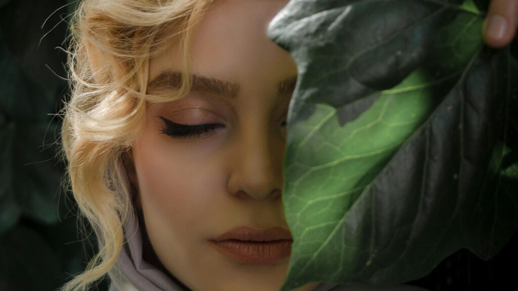 Blonde Woman Behind A Leaf Beauty Portrait 4K Desktop Wallpaper
