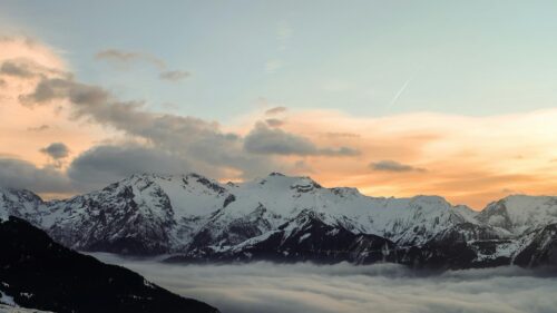 Breathtaking Snowy Mountain Peaks at Sunset Desktop Wallpaper