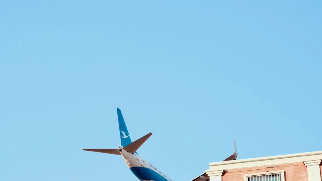 Minimalist Blue Sky Airplane Tail Aviation 4K Desktop Wallpaper