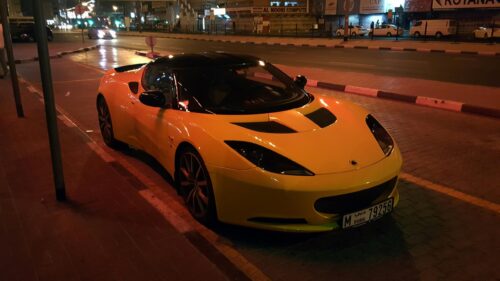 Yellow Lotus Evora Sports Car Parked at Night in Dubai 4K Wallpaper