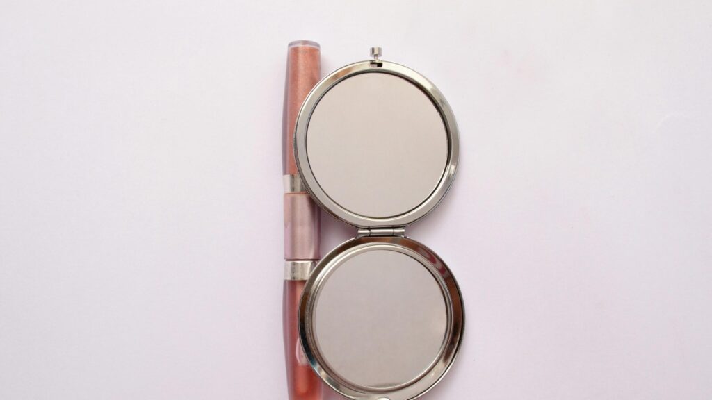 Minimalist Makeup Mirror and Lip Gloss Elegance 4K Wallpaper