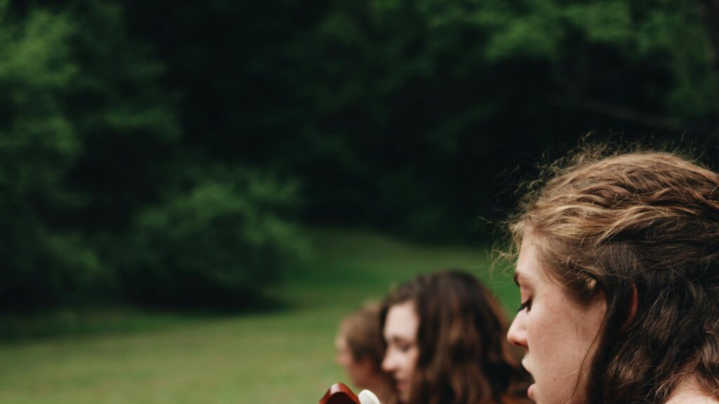 Close-up Portrait of Friends Singing Outdoors Desktop Wallpaper