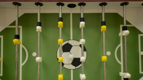 High-Angle View of a Foosball Table Green Pitch Desktop Wallpaper