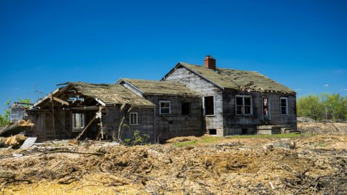 Abandoned Weathered Wooden House in Ruins under Clear Blue Sky PC Wallpaper