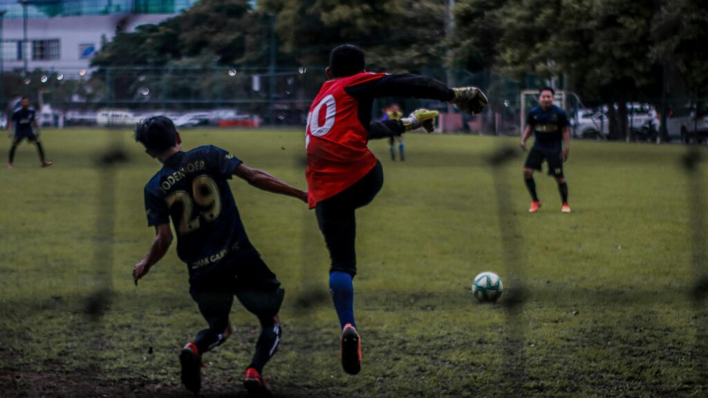 Goalkeeper Saves Goal in Intense Soccer Match 4K Desktop Wallpaper