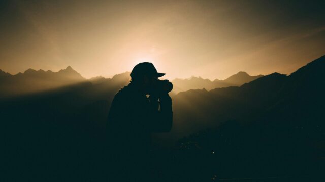 Silhouette Photographer Mountains Golden Hour 4K Desktop Wallpaper