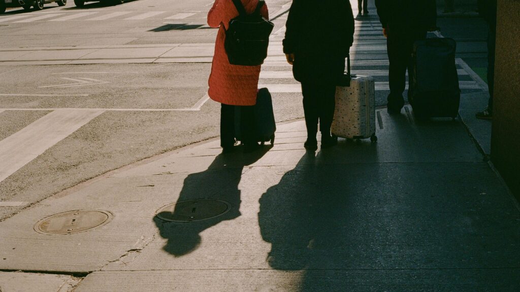 People Waiting at Crosswalk with Luggage Travel Scene Desktop Wallpaper