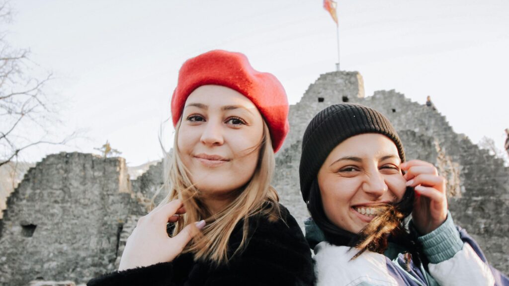 Two Happy Friends Posing Before Ancient Ruins Desktop Wallpaper