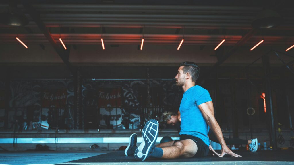 Athletic Man Stretching in Gym High Resolution 4K Desktop Wallpaper