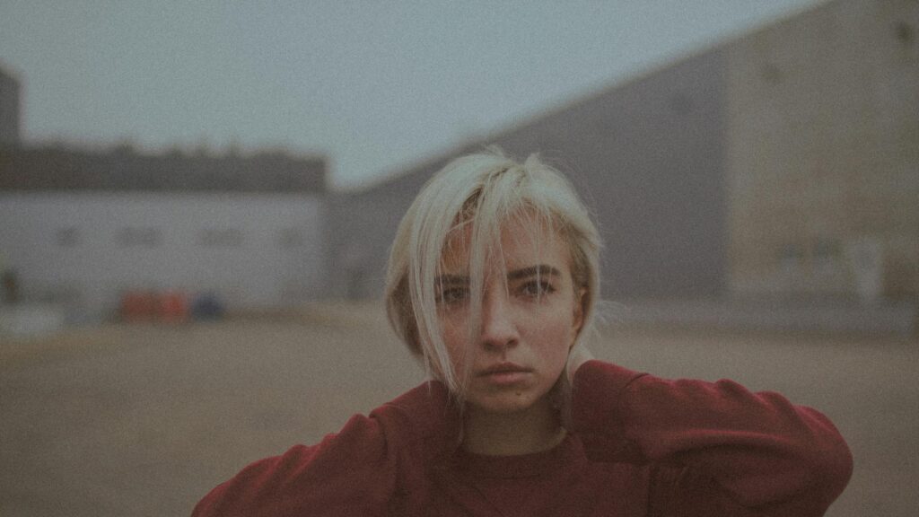 Sad Blonde Girl in Red Sweater Moody Portrait 4K Desktop Wallpaper
