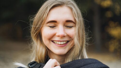Happy Young Blonde Woman Smiling with Closed Eyes 4K Wallpaper