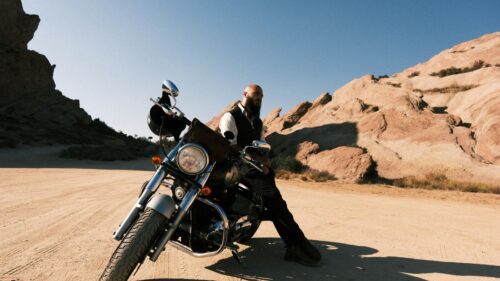Rugged Biker in Desert Landscape 4K Desktop Wallpaper
