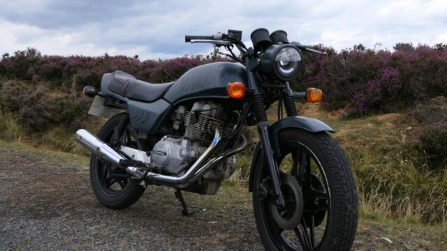 Vintage Honda Motorcycle on a Misty Purple Heather Hillside Desktop Wallpaper