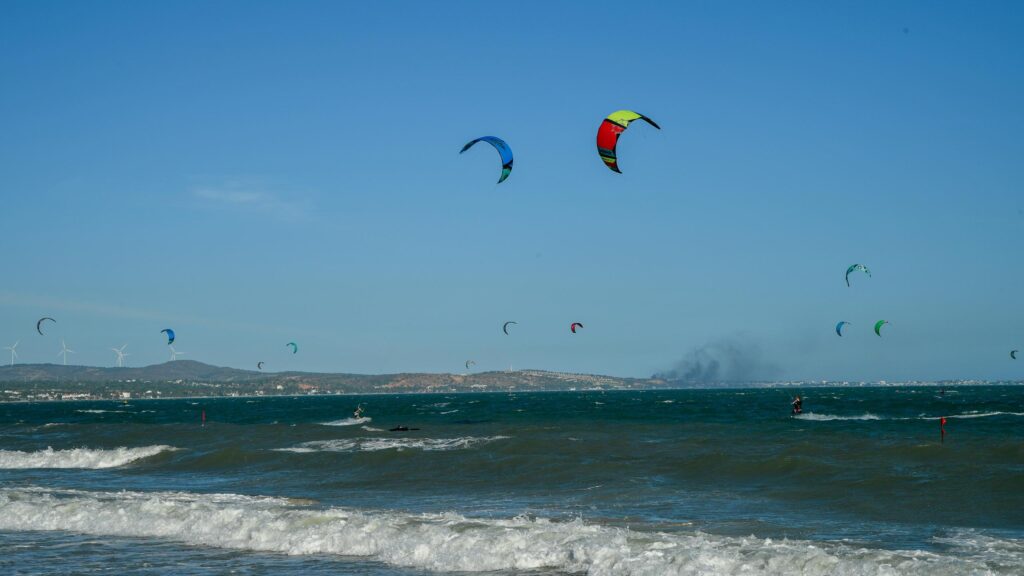 Kitesurfing Paradise Under A Clear Blue Sky Desktop Wallpaper