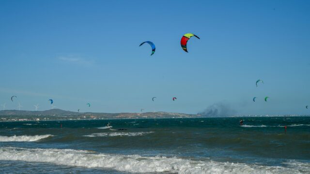 Kitesurfing Paradise Under A Clear Blue Sky Desktop Wallpaper