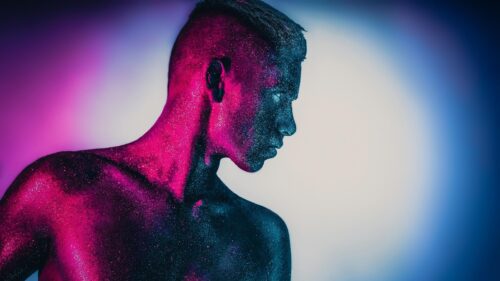 Man Covered in Neon Glitter Studio Portrait 4K Wallpaper
