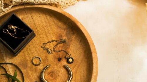 Elegant Gold Jewelry on Wooden Tray 4K Desktop Wallpaper