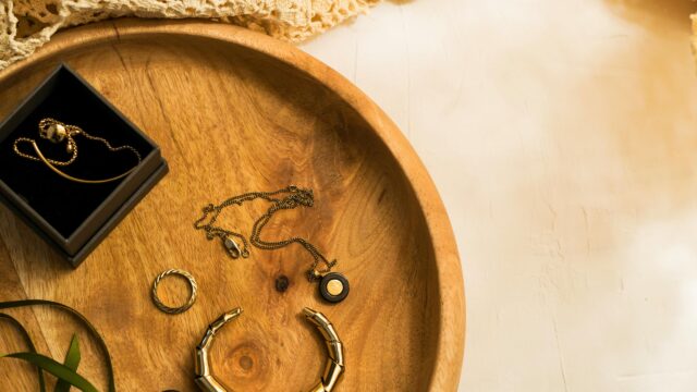 Elegant Gold Jewelry on Wooden Tray 4K Desktop Wallpaper