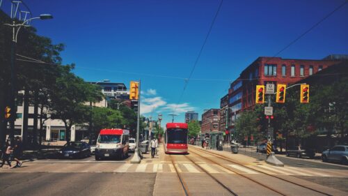 Red Streetcar Driving Through Downtown Toronto Urban Scene PC Wallpaper