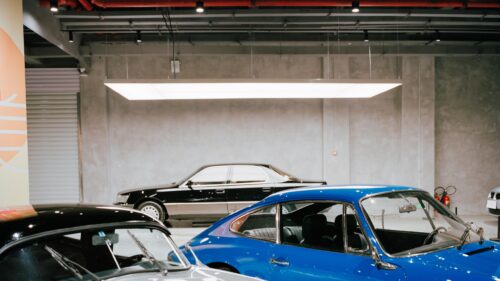 Classic Porsche and Vintage Sedan in Minimalist Garage Desktop Wallpaper