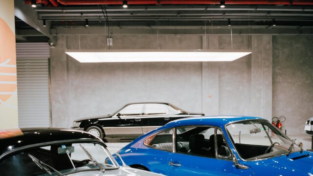 Classic Porsche and Vintage Sedan in Minimalist Garage Desktop Wallpaper
