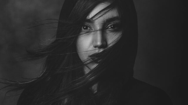 Mysterious Woman with Flowing Hair Monochrome Portrait Desktop Wallpaper