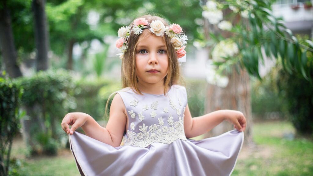 Adorable Little Girl with Flower Crown in Summer Garden 4K Wallpaper